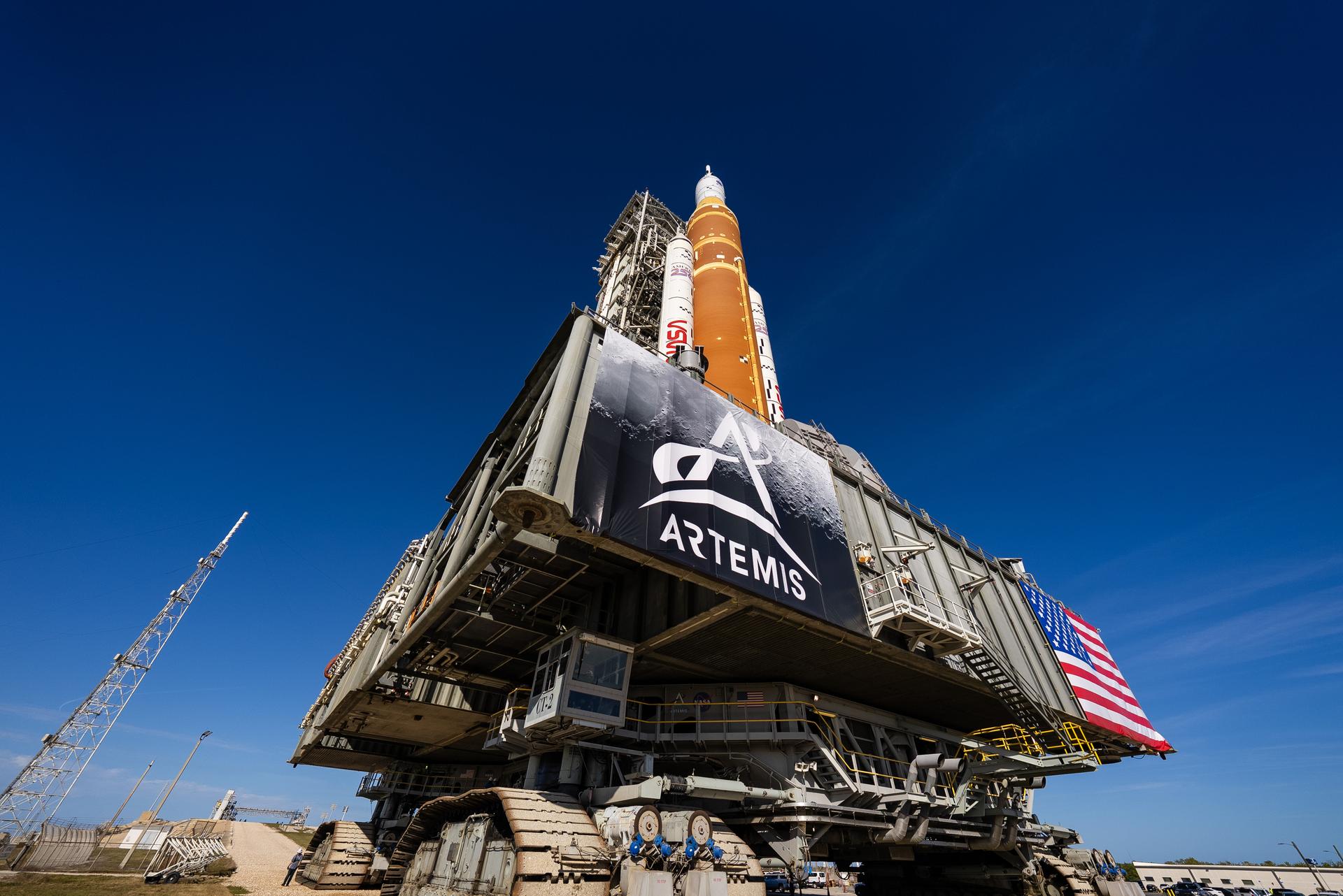 This image shows NASA’s SLS (Space Launch System) and Orion spacecraft rolling out of the Vehicle Assembly Building at NASA’s Kennedy Space Center. NASA's massive Crawler-Transporter, upgraded for the Artemis program, carries the powerful SLS rocket and Orion spacecraft on the Mobile Launcher from the Vehicle Assembly Building to Launch Pad 39B at Kennedy Space Center   in preparation for the Artemis II mission. 